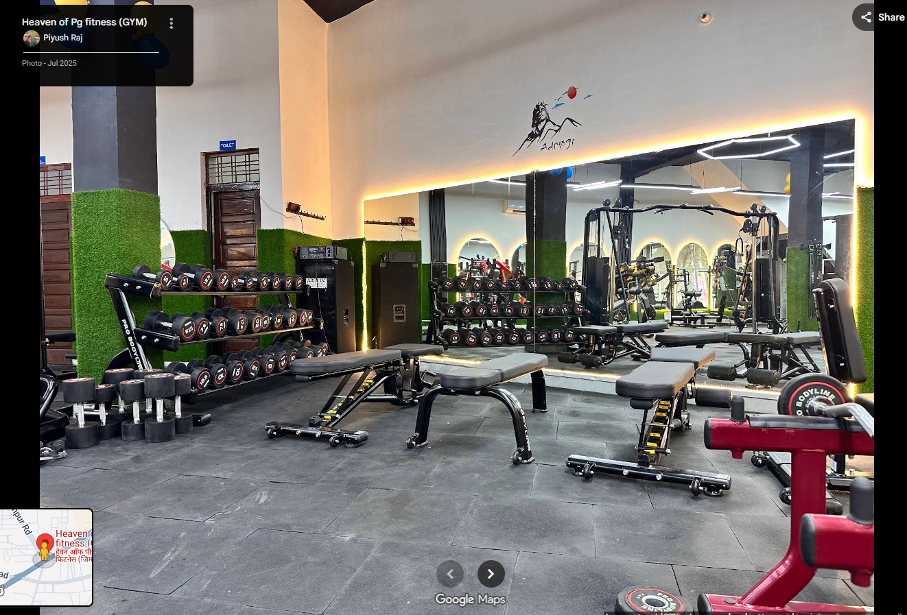 Inside Heaven of PG Fitness — dumbbell area with benches, mirrors, and strength equipment